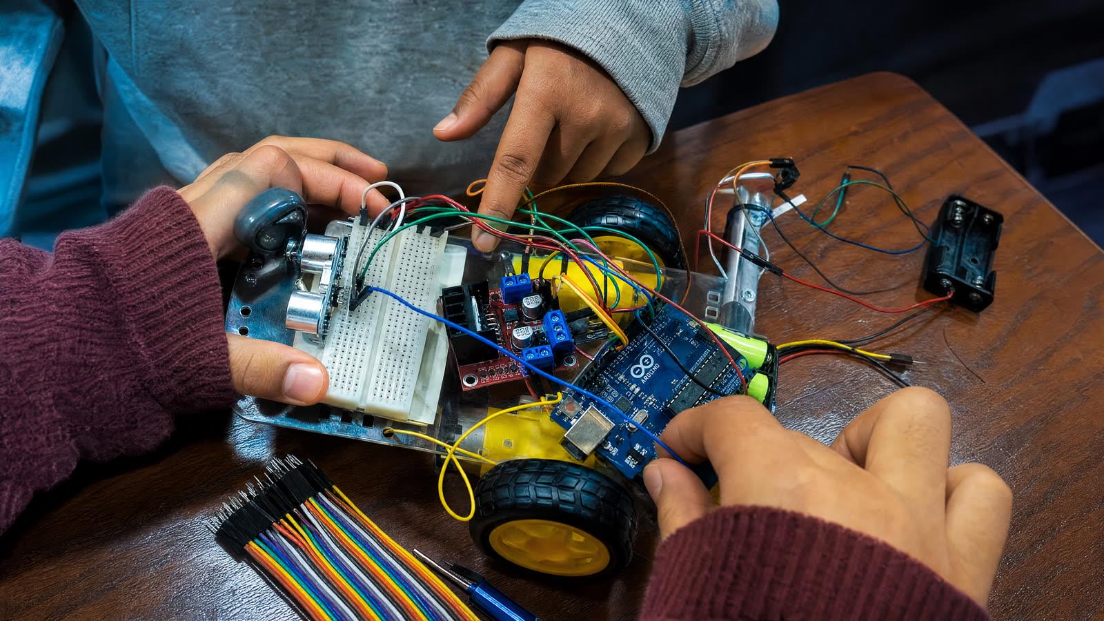 Students connecting components on a robot